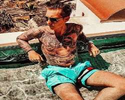 He is a tattoo freak and has his hands and chest full of various tattoos He is a tattoo freak and has his hands and chest full of various tattoos.